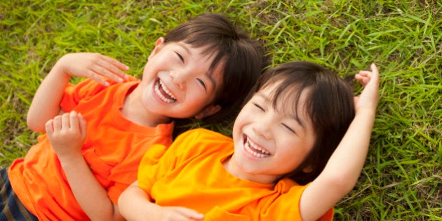 Twin boys lying on the grass