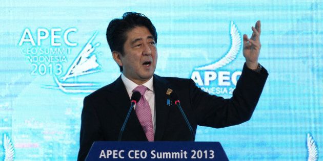 Shinzo Abe, Japan's prime minister, gestures as he delivers a keynote speech at the Asia-Pacific Economic Cooperation (APEC) CEO Summit in Nusa Dua, Bali, Indonesia, on Monday, Oct. 7, 2013. Japan must make certain deflation is 'swept away,' Abe said. Photographer: SeongJoon Cho/Bloomberg via Getty Images
