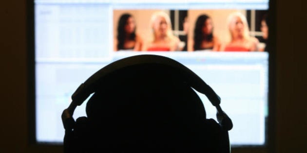 Los Angeles, UNITED STATES: A technician edits a pornographic movie at the Vivid Entertainment studio 30 January 2007 in Los Angeles. Blotches, blemishes and the occasional patch of cellulite: the high definition entertainment revolution has raised some hitherto unforeseen headaches for purveyors of pornography. But as his company prepares to release its first ever adult film on next generation Blu-Ray and HD-DVD discs, Vivid Entertainment chief Steve Hirsch is adamant the growing pains of 'hi-def' have been overcome. AFP PHOTO/GABRIEL BOUYS (Photo credit should read GABRIEL BOUYS/AFP/Getty Images)