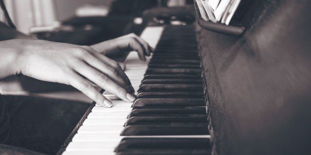 person playing upright piano in sephia photographyhttps://unsplash.com/photos/6JcFz_34qUM