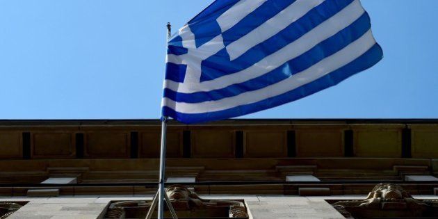 The Greek national flag is on display outside the Embassy of Greece to Germany on June 29, 2015 in Berlin. After talks between Athens and its creditors broke down, leaving Greece headed for an EU-IMF default and possible exit from the eurozone, the ECB said on June 28, 2015 it would keep open Emergency Liquidity Assistance (ELA) to the debt-hit country's banks. AFP PHOTO / JOHN MACDOUGALL (Photo credit should read JOHN MACDOUGALL/AFP/Getty Images)