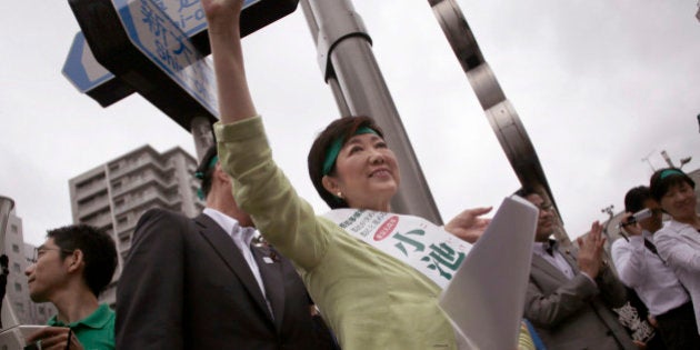 In this Friday, July 22, 2016 photo, former defense minister Yuriko Koike waves at passersby during her campaign rally for the Tokyo gubernatorial election in Tokyo. Japanâs capital with a population of more than 13 million people is voting Sunday, July 31, for its leader after two predecessors resigned over money scandals as Tokyo prepares to host the 2020 Olympics, and hopes to lead the nation in an economic turnaround. (AP Photo/Eugene Hoshiko)