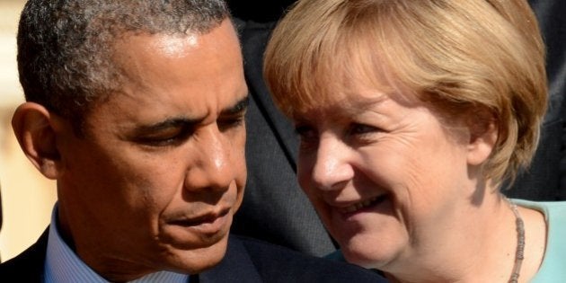 US President Barack Obama (L) stands nearby Germanys Chancellor Angela Merkel during the family picture of the G20 summit in Saint Petersburg on September 6, 2013. World leaders at the G20 summit on Friday failed to bridge their bitter divisions over US plans for military action against the Syrian regime, with Washington signalling that it has given up on securing Russia's support at the UN on the crisis. AFP PHOTO / KIRILL KUDRYAVTSEV (Photo credit should read KIRILL KUDRYAVTSEV/AFP/Getty Images)