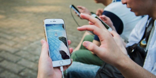 People play Nintendo Co.'s Pokemon Go augmented-reality game, developed by Niantic Inc., on their smartphones at Yoyogi Park in Tokyo, Japan, on Sunday, July 24, 2016. Nintendo shares plunged by the most since 1990 after the company said late Friday that the financial impact from the worldwide hit Pokemon Go will be limited. Photographer: Noriko Hayashi/Bloomberg via Getty Images