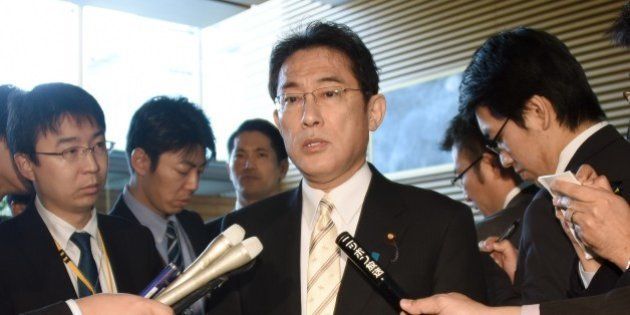Surrounded by journalists, Japanese Foreign Minister Fumio Kishida (C) answers questions after a cabinet meeting at the prime minister's official residence in Tokyo on December 25, 2015. Prime Minister Shinzo Abe ordered Foreign Minister Kishida to visit South Korea in a drive to resolve a bitter row over women systematically forced to have sex with Japanese soldiers during World War II. AFP PHOTO / Toru YAMANAKA / AFP / TORU YAMANAKA (Photo credit should read TORU YAMANAKA/AFP/Getty Images)