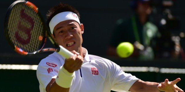 Japan's Kei Nishikori returns against Italy's Simone Bolelli during their men's singles first round match on day one of the 2015 Wimbledon Championships at The All England Tennis Club in Wimbledon, southwest London, on June 29, 2015. RESTRICTED TO EDITORIAL USE -- AFP PHOTO / LEON NEAL (Photo credit should read LEON NEAL/AFP/Getty Images)