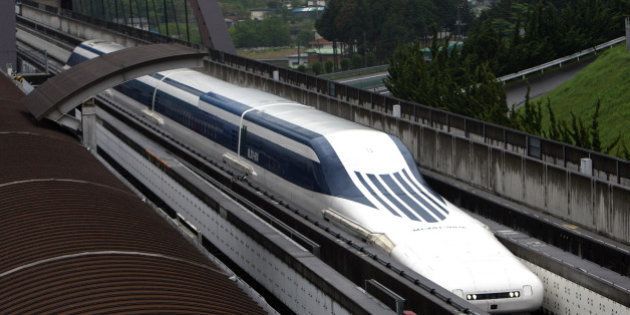 A magnetic-levitation (maglev) train passes at Central Japan Railway Co.'s Yamanashi Maglev test line in Tsuru City, Yamanashi Prefecture, Japan, on Tuesday, May 11, 2010. U.S. Transportation Secretary Ray LaHood is due to ride a 500 kilometers per hour (311 miles per hour) magnetic-levitation train in Japan today, spurring optimism in the Asian nation about selling such trains in America. Photographer: Tomohiro Ohsumi/Bloomberg via Getty Images