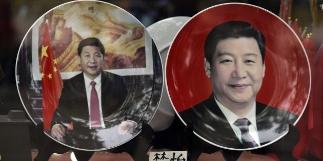 Decorative plates featuring Chinese President Xi Jinping are seen in a shop window in Beijing on October 20, 2014. Leaders of China's ruling Communist Party opened a highly-anticipated meeting on October 20 as state media emphasised the need to strengthen the country's legal system. AFP PHOTO/Greg BAKER (Photo credit should read GREG BAKER/AFP/Getty Images)