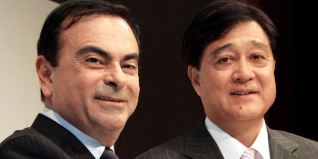 Carlos Ghosn, president and chief executive officer of Nissan Motor Co., left, shakes hands with Osamu Masuko, president of Mitsubishi Motors Corp., during a news conference in Tokyo, Japan, on Tuesday, Dec. 14, 2010. Nissan Motor Co. and Mitsubishi Motors Corp. will set up a 50-50 joint company next year to develop minicars for Japan to help boost sales, expanding an alliance under which the companies supply vehicles to each other. Photographer: Haruyoshi Yamaguchi/Bloomberg via Getty Images ***Local Caption*** Carlos Ghosn, Osamu Masuko