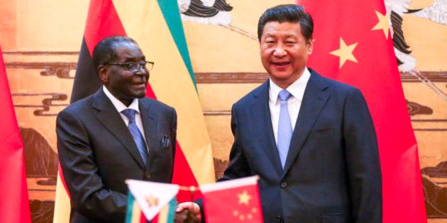 Zimbabwean President Robert Mugabe, left, looks on as his Chinese counterpart Xi Jinping applauds during a signing ceremony at the Great Hall of the People in Beijing, China, Monday, Aug. 25, 2014. Mugabe met with Xi on a visit to China hoping the long-time ally and economic giant can help the African nation's ailing economy. (AP Photo/Diego Azubel, Pool)