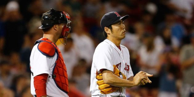 BOSTON, MA - JULY 1: A.J. Pierzynski #40 confers with Koji Uehara #19 of the Boston Red Sox in the ninth inning against the Chicago Cubs at Fenway Park on July 1, 2014 in Boston, Massachusetts. (Photo by Jim Rogash/Getty Images)