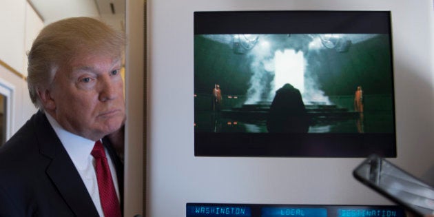 US President Donald Trump speaks to the press on Air Force One on April 6, 2017.Chinese President Xi Jinping touched down in Florida Thursday for a first face-to-face meeting with President Donald Trump, hoping that a basket full of 'tweetable' deals will help avoid a public clash.Trump had yet to arrive to Florida, but the pair will gather later at his Mar-a-Lago resort -- which the US president likes to call the 'Winter White House' -- for what promises to be a masterclass in studied informality. / AFP PHOTO / JIM WATSON (Photo credit should read JIM WATSON/AFP/Getty Images)