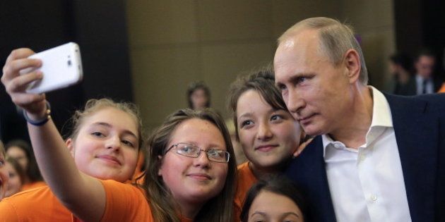 SOCHI, RUSSIA. MAY 10, 2016. Russia's President Vladimir Putin (R) poses for a photograph with kids at the Sirius education center for gifted children. Mikhail Metzel/TASS (Photo by Mikhail Metzel\TASS via Getty Images)