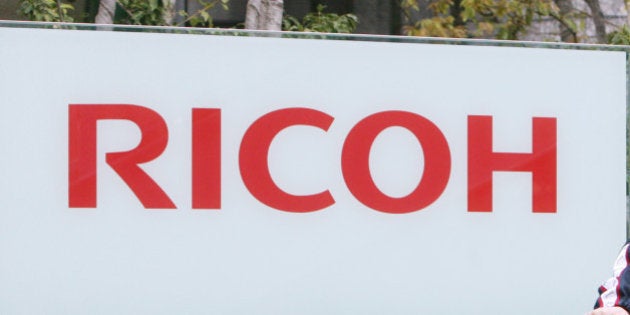 JAPAN - APRIL 18: A man cycles past the Ricoh Co. headquarters in Tokyo, Japan, on Wednesday, April 19,...