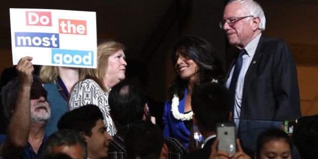 PHILADELPHIA, PA - JULY 26: Sen. Bernie Sanders along with his wife Jane O'Meara Sanders, stand with US representative Tulsi Gabbard (D-HI) during the second day of the Democratic National Convention at the Wells Fargo Center, July 26, 2016 in Philadelphia, Pennsylvania. An estimated 50,000 people are expected in Philadelphia, including hundreds of protesters and members of the media. The four-day Democratic National Convention kicked off July 25. (Photo by Jessica Kourkounis/Getty Images)