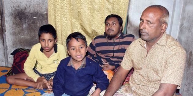 In this photograph taken on January 20, 2017, Bangladeshi father and fruit vendor Tofazzal Hossain (R), who has sparked a debate over assisted suicide, is seen with his two sons and grandson (2nd L) in Meherpur.Desperate to end their suffering, the impoverished Bangladeshi father has begged permission to kill three terminally ill members of his family, sparking a rare debate about euthanasia in a deeply conservative society. Hossain's sons, aged 24 and 13, and eight-year-old grandson, are afflicted with Duchenne Muscular Dystrophy. / AFP / STR / TO GO WITH Bangladesh-society,FOCUS (Photo credit should read STR/AFP/Getty Images)