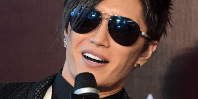 Japanese singer Gackt speaks on the red carpet as he arrives for the 6th Asian Film Awards in Hong Kong on March 19, 2012. AFP PHOTO / AARON TAM (Photo credit should read aaron tam/AFP/Getty Images)