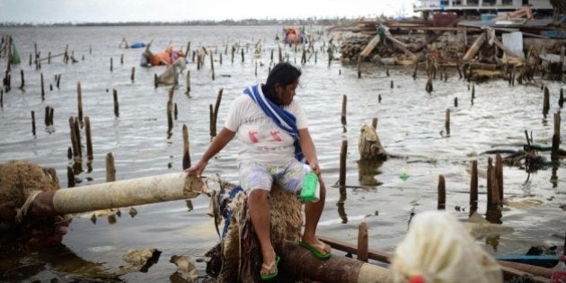 LEYTE, PHILIPPINES - NOVEMBER 20: A woman searches for usable materials on November 20, 2013 in Tacloban,...