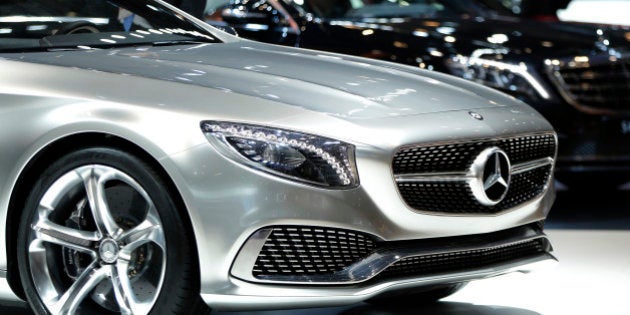 An attendee looks at Daimler AG's Mercedes-Benz Concept S-Class Coupe vehicle on display at the 43rd...
