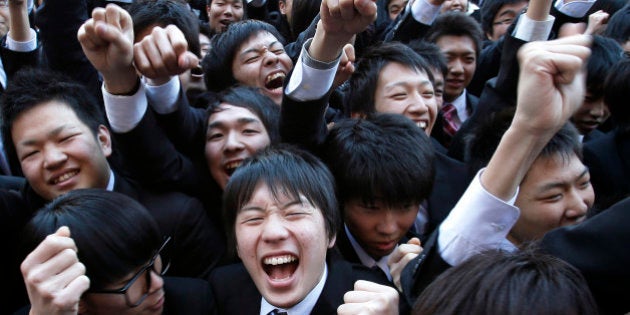 Vocational students raise their fists during a rally to start off job-hunting in Tokyo, Japan, on Wednesday, Feb. 13, 2013. Shinzo Abe?s government announced 10.3 trillion yen in spending last month, which it predicts will increase gross domestic product by about 2 percentage points and create about 600,000 jobs. Photographer: Kiyoshi Ota/Bloomberg via Getty Images