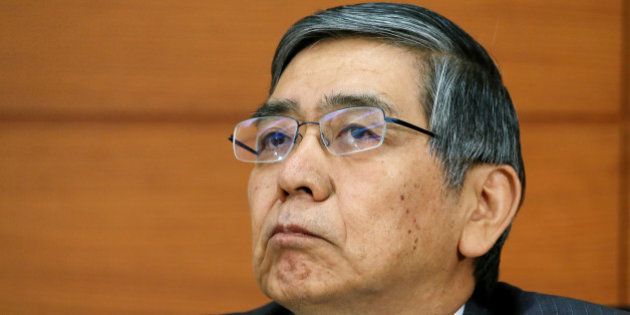 Haruhiko Kuroda, governor of the Bank of Japan (BOJ), listens during a news conference at the central bank's headquarters in Tokyo, Japan, on Thursday, Nov. 21, 2013. The Bank of Japan will alter a target of 2 percent inflation in two years as unprecedented bond-buying proves insufficient to achieve the goal, economists forecast in a Bloomberg News survey. Photographer: Haruyoshi Yamaguchi/Bloomberg via Getty Images