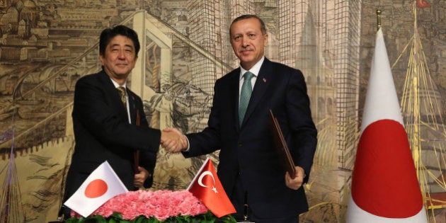 ISTANBUL, TURKEY - OCTOBER 29: Turkish Prime Minister Recep Tayyip Erdogan (R) and his Japanese counterpart Shinzo Abe (L) officialy sign an agreement on science and technology and nuclear energy field after an official meeting on October 29, 2013 at Prime Ministry office in Dolmabahce, Istanbul. (Photo By Ahmet Dumanli/Anadolu Agency/Getty Images)