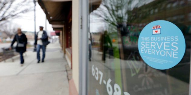 A window sticker on a downtown Indianapolis florist, Wednesday, March 25, 2015, shows it's objection to the Religious Freedom bill passed by the Indiana legislature. Organizers of a major gamers' convention and a large church gathering say they're considering moving events from Indianapolis over a bill that critics say could legalize discrimination against gays. (AP Photo/Michael Conroy)