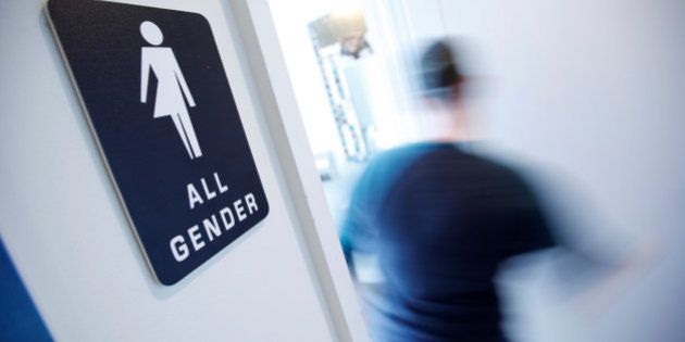 A bathroom sign welcomes both genders at the Cacao Cinnamon coffee shop in Durham, North Carolina May 3, 2016. The shop installed the signs after North Carolina's