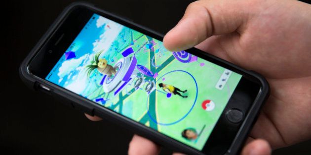 TOKYO, JAPAN - JULY 22: A man plays Pokemon Go game on a smartphone on July 22, 2016 in Tokyo, Japan. The Japanese version of the game app Pokemon Go was released on July 22, 2016. Japan McDonalds' 3,000 restaurants in Japan will be turned into Pokemon gyms in collaboration with the fast-food chain. (Photo by Tomohiro Ohsumi/Getty Images)