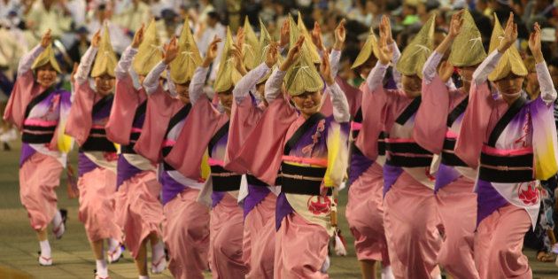 TOKUSHIMA, JAPAN - AUGUST 12: Japanese women dressed in traditional costume perform Awa-Odori dance during the annual 'Awa odori' or Awa Dance Festival on August 12, 2013 in Tokushima, Japan. The traditional Japanese dancing performance festival is held from 12 to 15 August as part of the Obon festival, attracting over 1.3 million tourists. (Photo by Buddhika Weerasinghe/Getty Images)