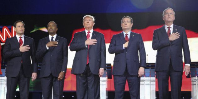 2016 Republican presidential candidates Senator Marco Rubio, a Republican from Florida, from left, Ben Carson, retired neurosurgeon, Donald Trump, president and chief executive of Trump Organization Inc., Senator Ted Cruz, a Republican from Texas, and Jeb Bush, former governor of Florida, listen to the U.S. National Anthem during the Republican presidential candidate debate at The Venetian in Las Vegas, Nevada, U.S., on Tuesday, Dec. 15, 2015. With less than two months remaining before the Feb. 1 Iowa caucuses and the Feb. 9 New Hampshire primary, middle-of-the-pack candidates hoping for a late surge in the polls have little choice but to come out swinging in tonight's fifth Republican debate. Photographer: Ruth Fremson/Pool via Bloomberg