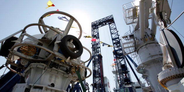 The finder-installed power grab (FPG), left, and on-board drilling machine system, center, sit on Japan...