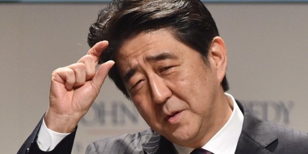 Japanese Prime Minister Shinzo Abe gestures as he delivers a speech at the first international symposium on President Kennedy hosted by the JFK Library Foundation and Waseda University in Tokyo on March 18, 2015. Former US President Bill Clinton attended the symposium entitled 'The Torch Has Been Passed: JFK's Legacy Today'. AFP PHOTO / KAZUHIRO NOGI (Photo credit should read KAZUHIRO NOGI/AFP/Getty Images)