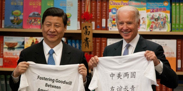 Xi Jinping, vice president of China, left, and U.S. Vice President Joe Biden stand for a photograph while visiting the International Studies Learning Center in South Gate, California, U.S., on Friday, Feb. 17, 2012. Xi wraps us his trip to the U.S. today and will fly to Ireland for an official visit and then to Turkey to meet with Minister Recep Tayyip Erdogan in Ankara on Feb. 21 before returning to China. Photographer: Tim Rue/Bloomberg via Getty Images