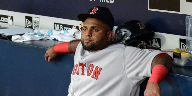Boston Red Sox third baseman Pablo Sandoval (48) sits on the bench before the start of a baseball game against the Atlanta Braves Thursday, June 18, 2015, in Atlanta. Boston third baseman Pablo Sandoval has been benched by manager John Farrell after using his Instagram account during a loss to the Braves on Wednesday. (AP Photo/Jon Barash)
