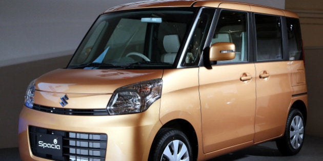 A Suzuki Motor Corp. Spacia minicar is displayed at its unveiling in Tokyo, Japan, on Tuesday, Feb. 26, 2013. Suzuki aims to sell 580,000 minicars in Japan in 2013, Chief Executive Officer Osamu Suzuki told reporters today. Photographer: Haruyoshi Yamaguchi/Bloomberg via Getty Images