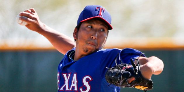 Texas Rangers pitcher Kyuji Fujikawa pitches in an intrasquad game prior to a spring training baseball game against the Seattle Mariners Friday, March 20, 2015, in Surprise, Ariz. (AP Photo/Lenny Ignelzi)