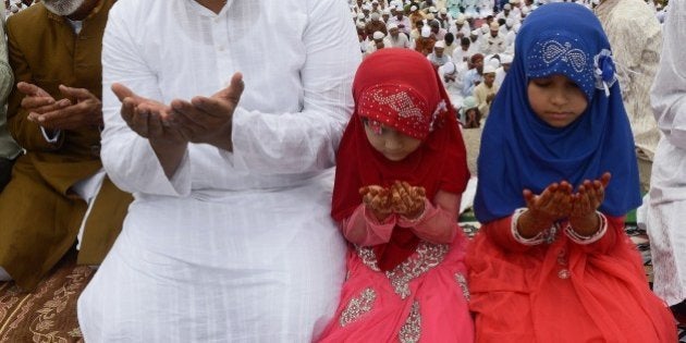 Indian Muslim devotees offer Eid prayers during the start of the Eid al-Fitr festival at the Quli Qutubshahi Eidgah in Hyderabad on July 29, 2014. Muslims around the world are celebrating Eid al-Fitr marking the end of the holy month of Ramadan during which followers are required to abstain from food, drink and sex from dawn to dusk. AFP PHOTO/NOAH SEELAM (Photo credit should read NOAH SEELAM/AFP/Getty Images)