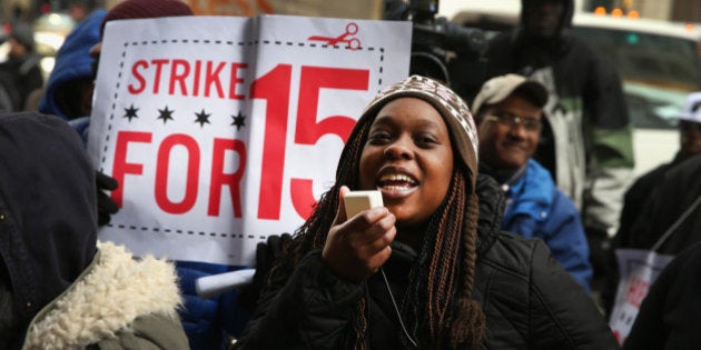 CHICAGO, IL - DECEMBER 05: Charde Nabors, a Sears employee, protests with fast-food and retail workers demanding higher pay outside a Sears store in the Loop on December 5, 2013 in Chicago, Illinois. Organizers have called for a one-day labor walkout at fast-food restaurants and retail stores and demonstrations in 100 cities. (Photo by Scott Olson/Getty Images)