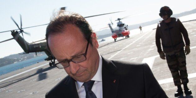 French President Francois Hollande waits for guests aboard the Charles de Gaulle aircraft carrier off shore near Toulon, southern France, on August 15, 2014 as part of ceremonies marking the 70th anniversary of the Allied landing in Provence. Two months after D-Day, the Allied invasion of southern France pushed the exhausted Nazi army back towards Germany and hastened the end of World War II in Europe. AFP PHOTO / POOL / PHILIPPE WOJAZER (Photo credit should read PHILIPPE WOJAZER/AFP/Getty Images)