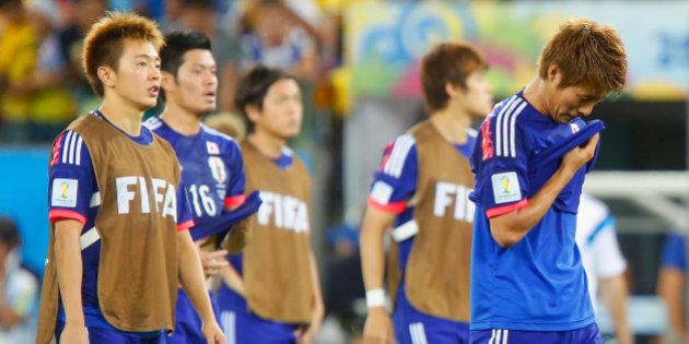CUIABA, BRAZIL - JUNE 24: A dejected Manabu Saito and Yoichiro Kakitani of Japan after defeat in the 2014 FIFA World Cup Brazil Group C match between Japan and Colombia at Arena Pantanal on June 24, 2014 in Cuiaba, Brazil. (Photo by Gabriel Rossi/Getty Images)