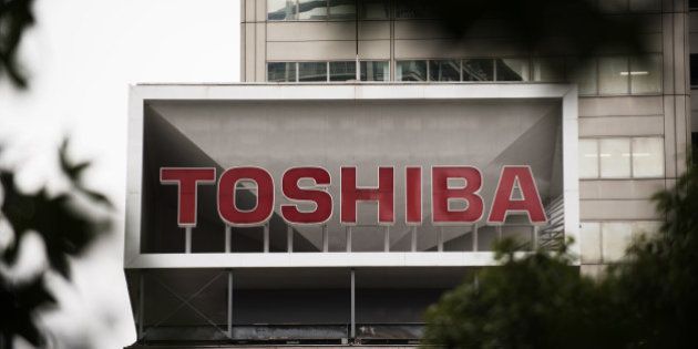 The Toshiba Corp. logo is displayed atop the company's headquarters in Tokyo, Japan, on Monday, August 31, 2015. Toshiba gained the most in more than four years in Tokyo trading after appointing Masashi Muromachi as president and projecting an annual loss, steps toward wrapping up an accounting scandal that may cost $1.2 billion. Photographer: Akio Kon/ Bloomberg