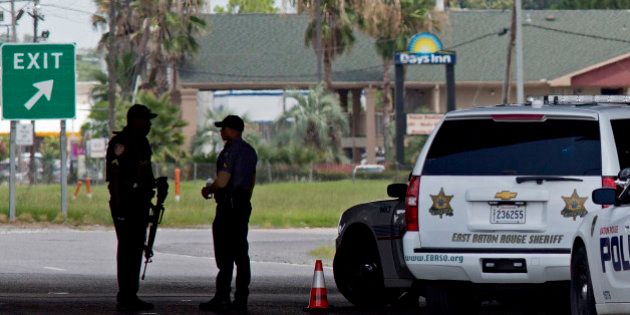 Baton Rouge Police with assault rifles block Airline Highway after police were shot in Baton Rouge, La., Sunday, July 17, 2016. Authorities say multiple law enforcement officers have been killed and injured in a shooting in Baton Rouge Sunday. (AP Photo/Max Becherer)