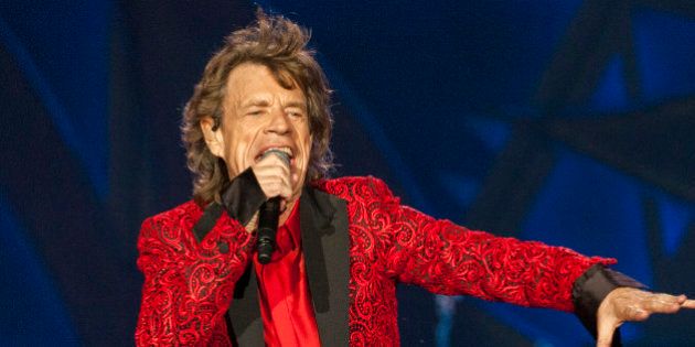 FILE - In this July 4, 2015 file photo, Mick Jagger of the Rolling Stones performs at the Indianapolis Motor Speedway in Indianapolis, Ind. Jagger's representatives say the rock legend is expecting his eighth child. The representatives confirmed a report by People magazine and other media outlets that Jagger's girlfriend, Melanie Hamrick, 29, is pregnant. (Photo by Barry Brecheisen/Invision/AP, File)