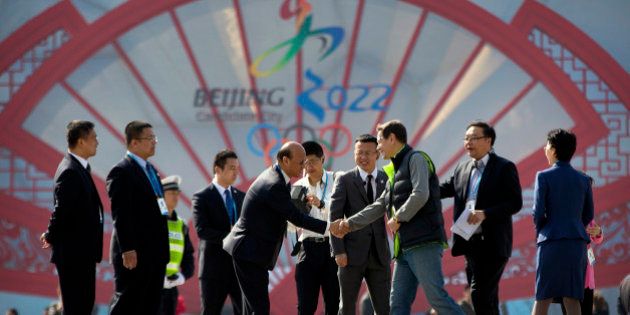 BEIJING, CHINA - MARCH 24: Alexander Zhukov, head of the 2022 Evaluation Commission for the International Olympic Committee (IOC), third from right, shakes hands with representatives of Beijing's 2022 Winter Olympics bid committee outside of the Beijing National Aquatics Center, also known as the Water Cube, on March 24, 2015 in Beijing, China. (Photo by Mark Schiefelbein-Pool/Getty Images)
