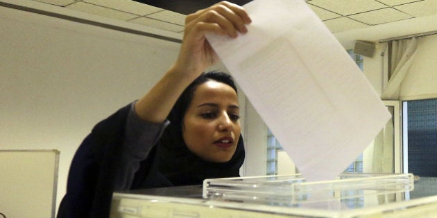 A Saudi woman casts her ballot at a polling center during municipal elections in Riyadh, Saudi Arabia, Saturday, Dec. 12, 2015. Saudi women are heading to polling stations across the kingdom on Saturday, both as voters and candidates for the first time in this landmark election. (AP Photo/Aya Batrawy)