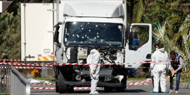 Investigators continue to work at the scene near the heavy truck that ran into a crowd at high speed killing scores who were celebrating the Bastille Day July 14 national holiday on the Promenade des Anglais in Nice, France, July 15, 2016. REUTERS/Eric Gaillard