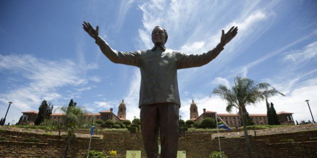 PRETORIA, SOUTH AFRICA - DECEMBER 16: A statue of former South African president Nelson Mandela is unveiled at the Union Buildings on December 16, 2013 in Pretoria, South Africa. South African president Jacob Zuma unveiled a 9 meter bronze statue of former South African president Nelson Mandela as part of the Day of Reconciliation celebrations. (Photo by Oli Scarff/Getty Images)