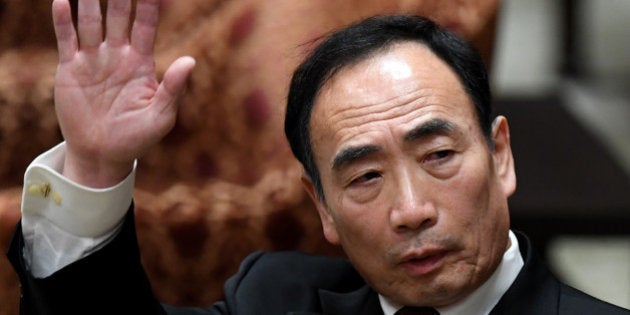 Yasunori Kagoike, operator of a nationalistic school in Osaka, raises his hand while giving a sworn testimony to a lower house budget committee in Tokyo on March 23, 2017.Japanese Prime Minister Shinzo Abe's approval rating has fallen sharply, an opinion poll showed on March 20, as scandals erode public confidence in a government now in its fifth year. Kagoike recently claimed he received a 8,800 USD donation from Abe for his primary school, plans for which now have been put on ice. / AFP PHOTO / Toshifumi KITAMURA (Photo credit should read TOSHIFUMI KITAMURA/AFP/Getty Images)