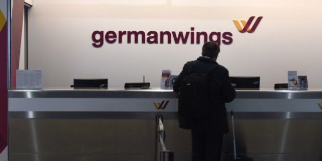 A man check in at a counter of German airline German Wings in Cologne/Bonn airport on March 24, 2015 in Cologne, western Germany . The head of low-budget airline Germanwings said there were 144 passengers and six crew on the Airbus A320 that crashed in the French Alps en route to Duesseldorf from Barcelona. AFP PHOTO / PATRIK STOLLARZ (Photo credit should read PATRIK STOLLARZ/AFP/Getty Images)